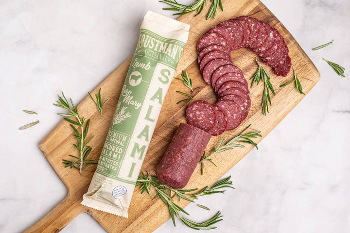 Lamb Rosemary Salami by Foustman's, all-natural uncured salami with rosemary on a cutting board with rosemary.