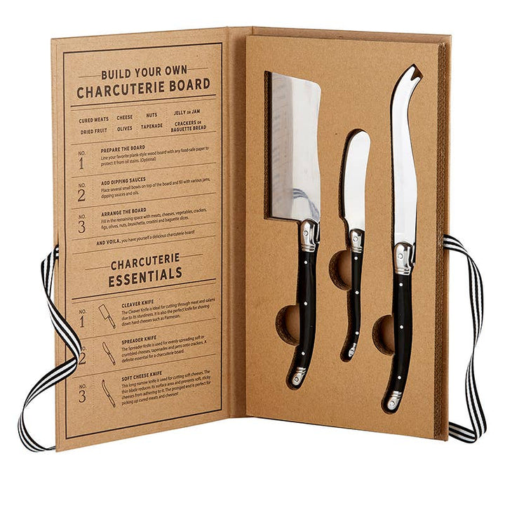 Charcuterie Essentials Book Box Contents: Cleaver Knife, Spreader Knife, Soft Cheese Knife made of stainless steel with elegant black handles.