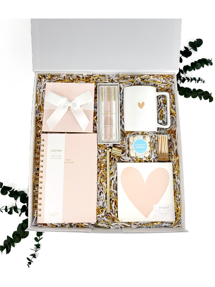 Blush and Bliss Gift Box featuring planner, candle, mug, pen set, matches, and gourmet treats.