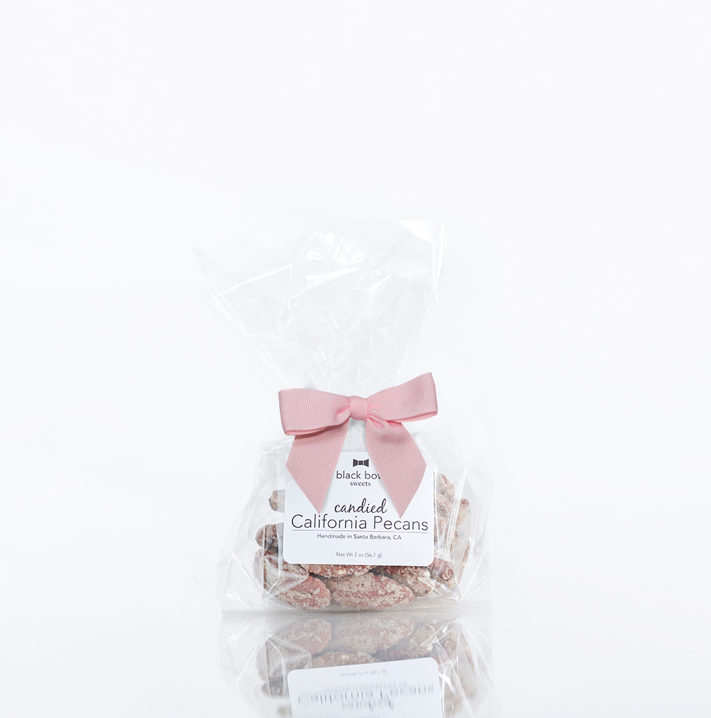 Gourmet candied pecans tied with a pink ribbon, perfect for gifting.