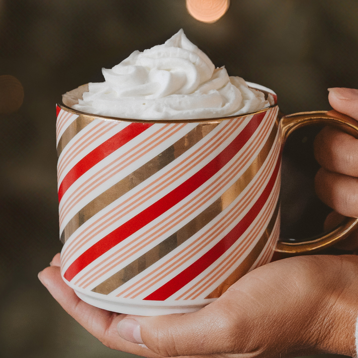 Candy Cane Coffee Mug with red and white candy cane design and gold handle.