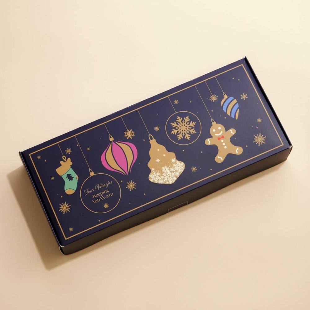 Navy blue gift box with decorative holiday ornament designs. 