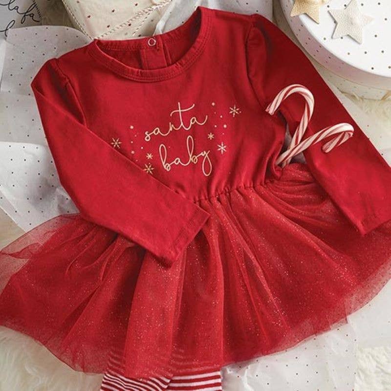 Close-up view of Santa Baby Tutu Dress displayed with candy canes and candy cane striped tights.