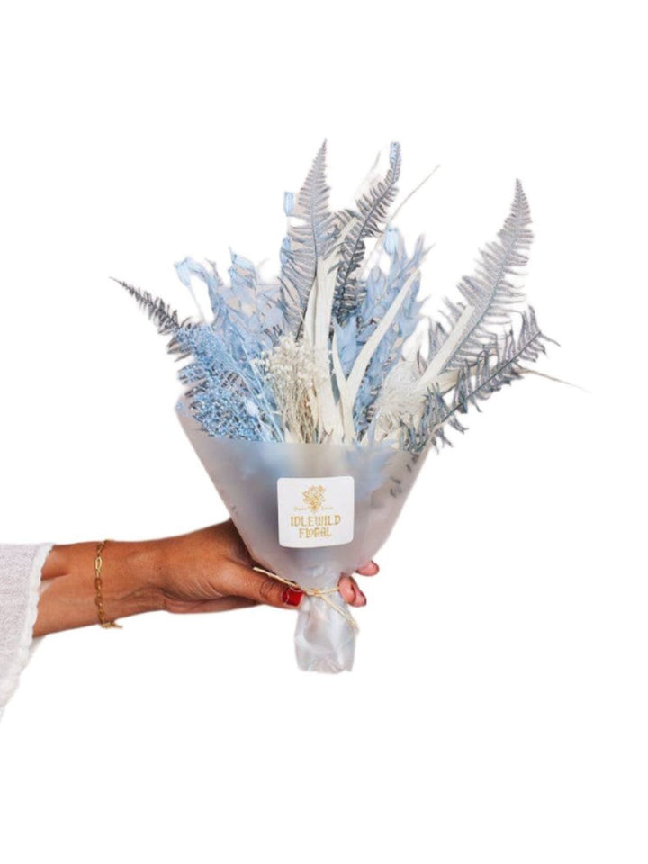 Close-up of Cloud Dried Flower Bouquet with soft blue and cream tones on a white background.