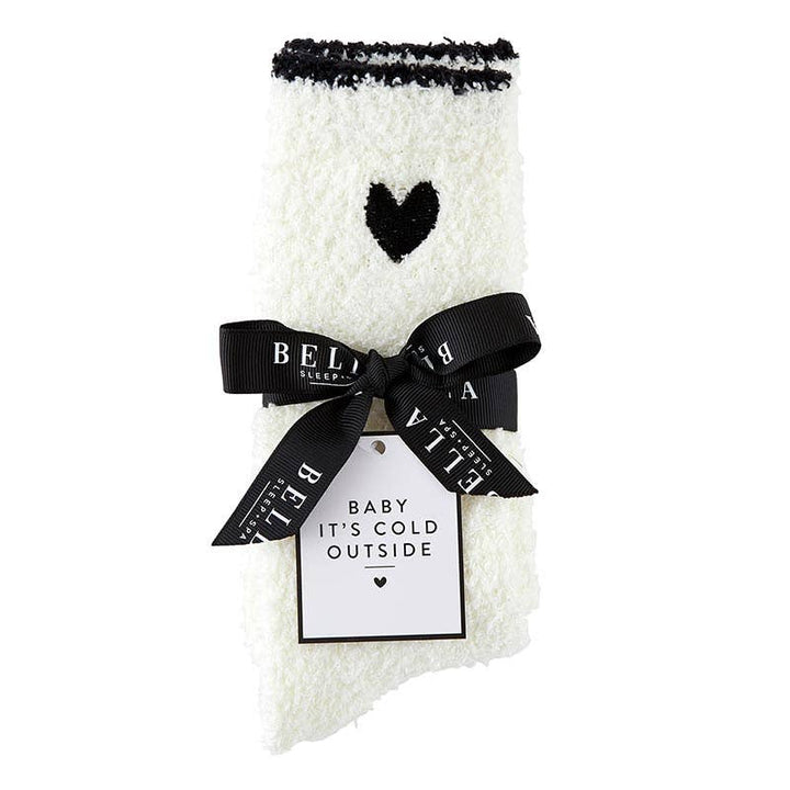 Cozy socks tied with a black ribbon and a gift tag that reads “Baby It's Cold Outside,” ready for holiday gifting.