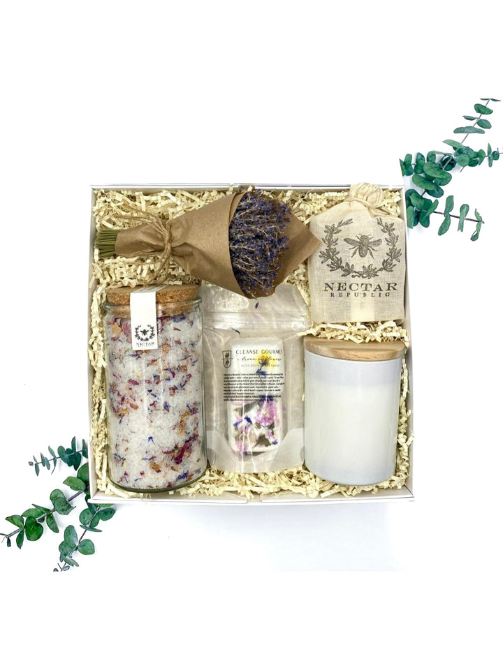 Dream In Flowers Gift Box with luxurious botanical treasures including bath soak, handcrafted soap, shower steamers, a soothing candle, and a lavender bundle.