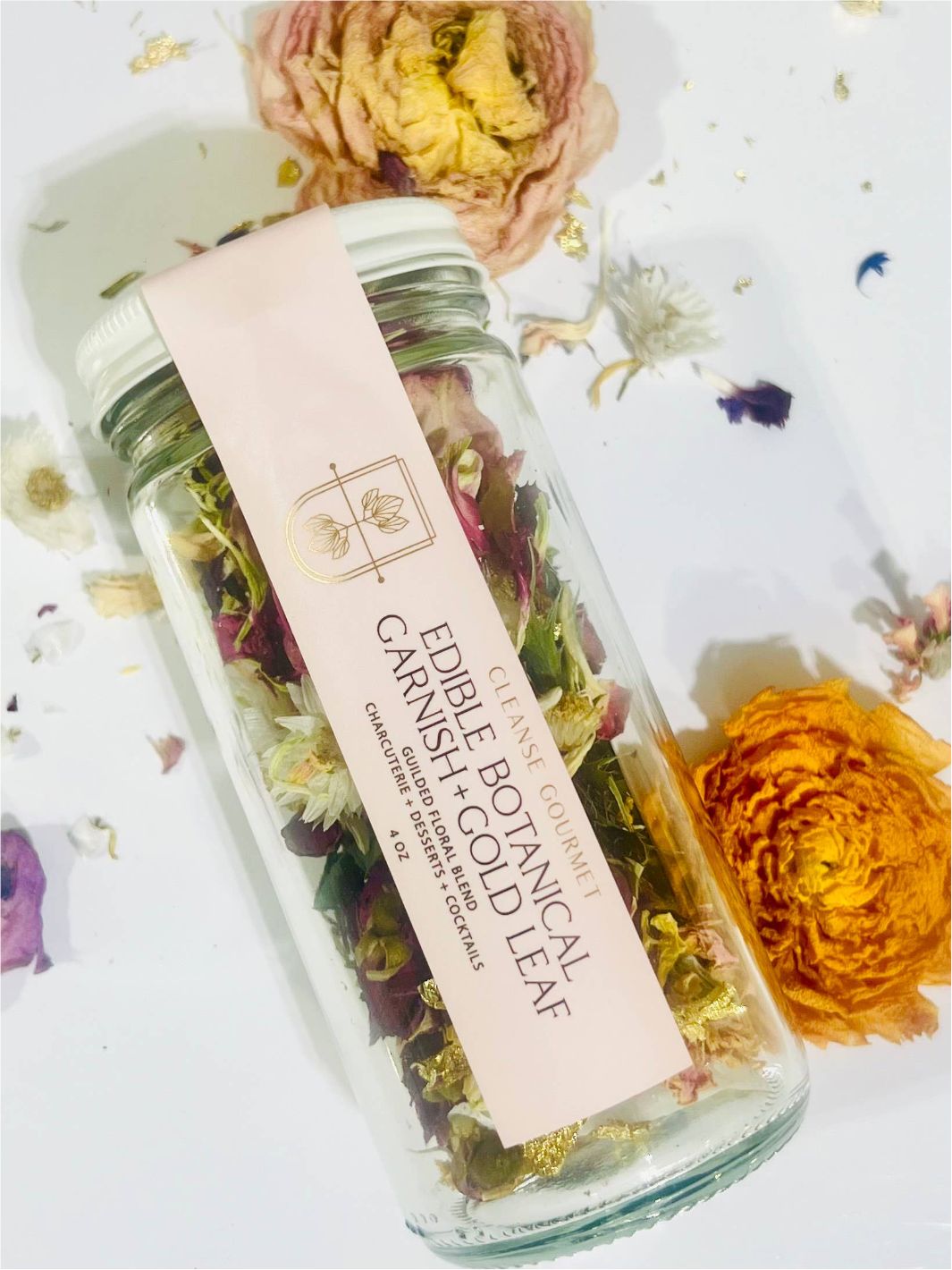 Edible Botanical Garnish + Gold Leaf by Cleanse Gourmet in a glass jar.