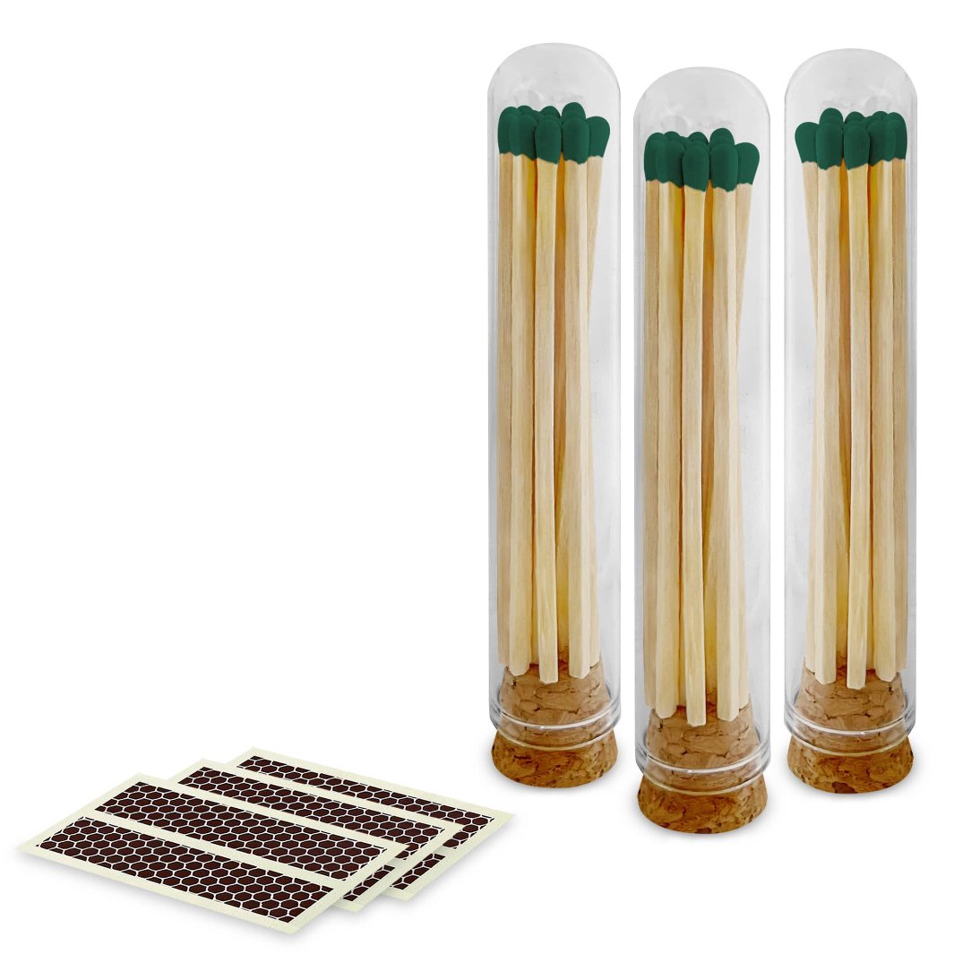 Evergreen color-tipped matches in a glass cloche, showing rustic charm.