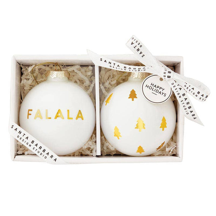 FaLaLa & Trees Glass Ornament Set in Gift Box: Two glass ornaments, one with "FaLaLa" in gold script and the other with gold Christmas trees, displayed in a stylish gift box. 