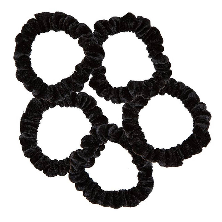 Close-up of five black velvet scrunchies 