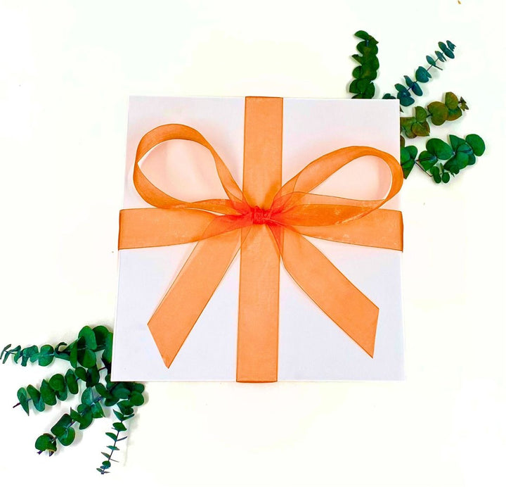 White World of Gifting Gift Box with Orange Chiffon Ribbon.