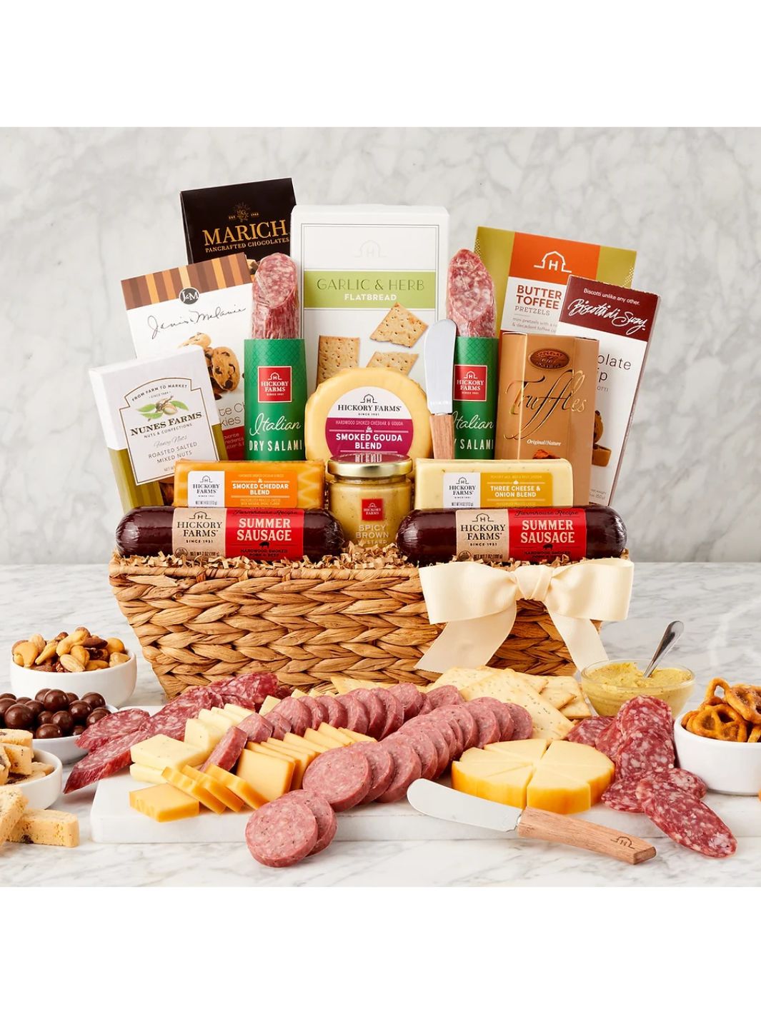 Gourmet Gatherings Gift Basket featuring sausage, cheese, flatbread, and sweet treats in a woven basket with a bow.