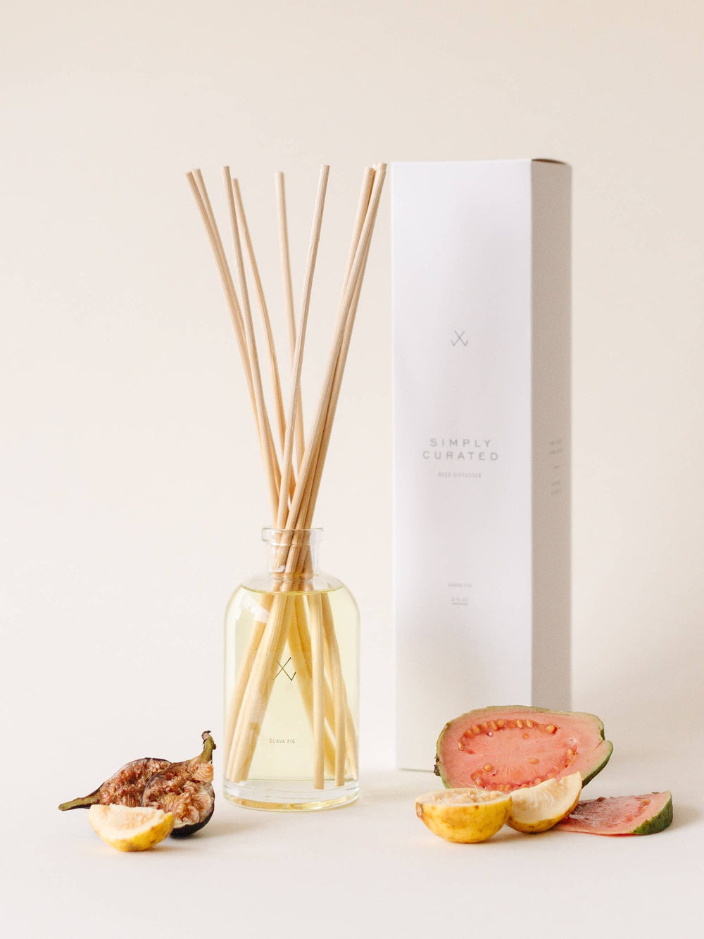 A styled Guava Fig Diffuser with figs, guava, and lemons.