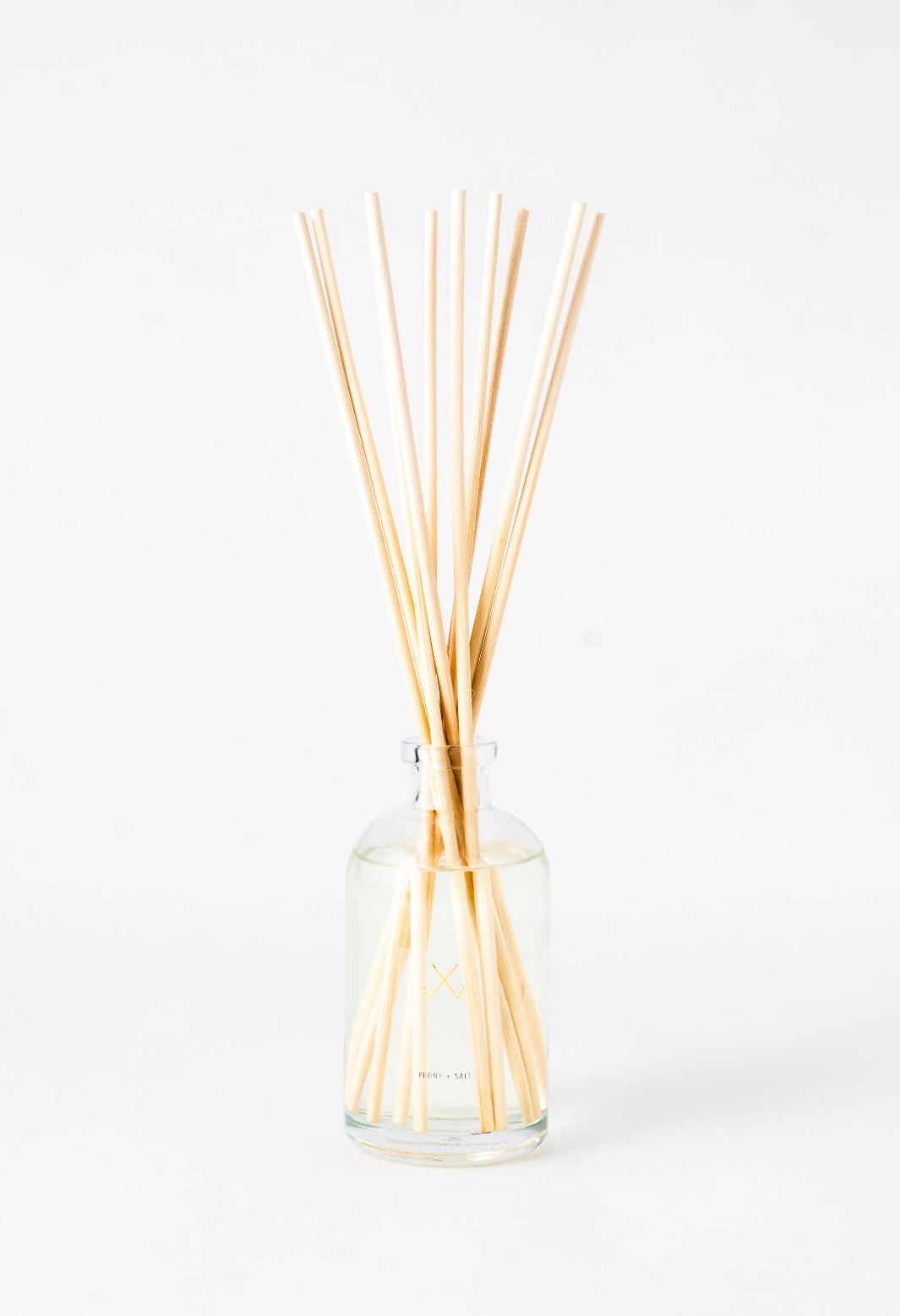 Guava Fig Reed Diffuser in a glass bottle with natural rattan reeds.