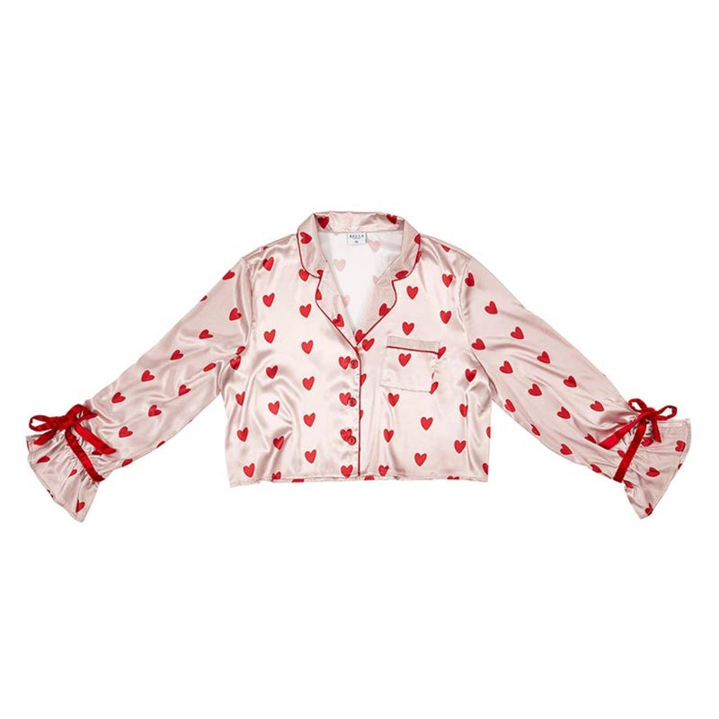 Silky satin long-sleeve pajama top in pink with red hearts, featuring red velvet ribbon ties on the sleeves for a romantic touch.