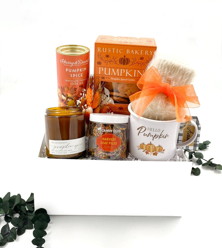 Hello Pumpkin Gift Box with mug, cozy socks, pumpkin spice cocoa, cookies, candle, and autumn-themed chocolates.