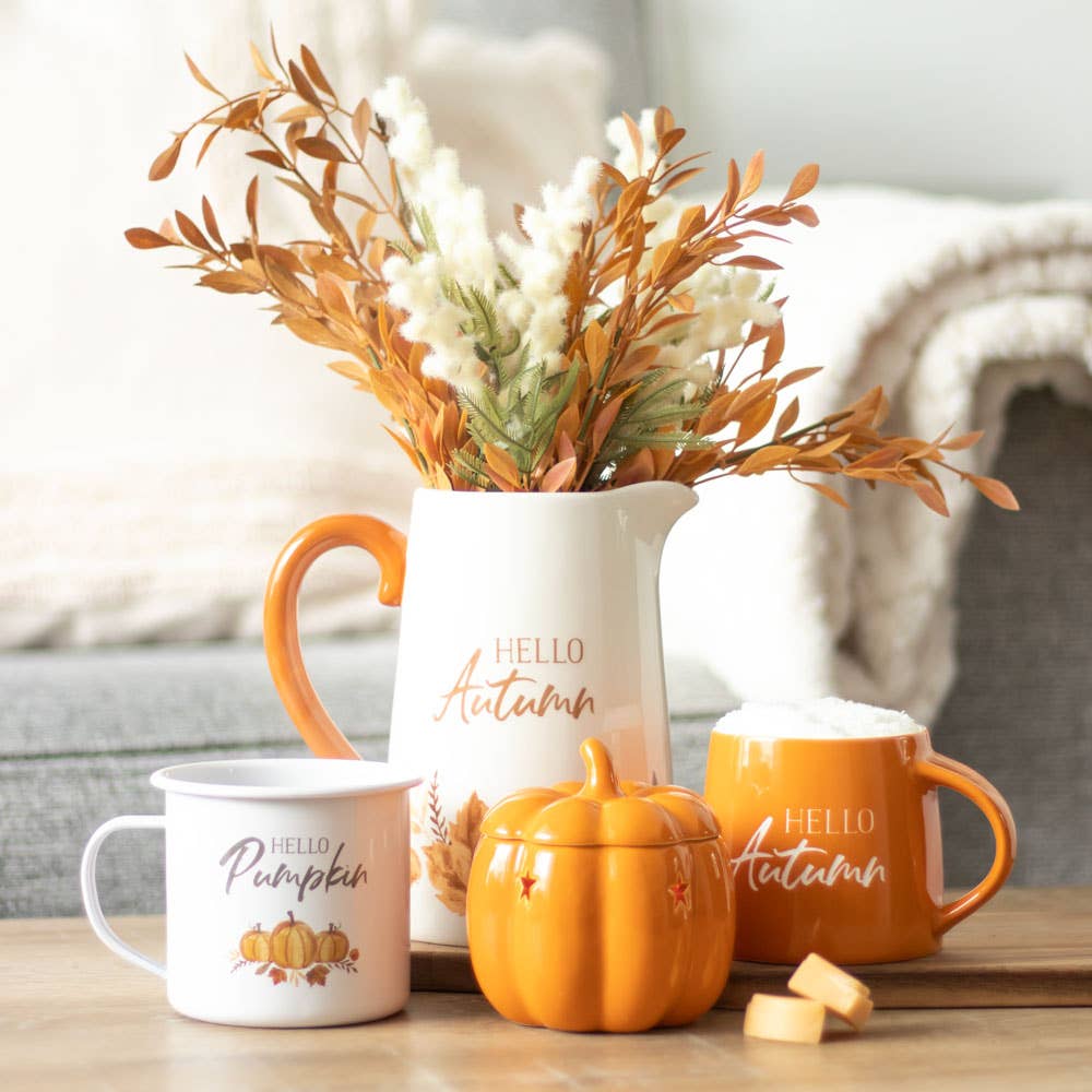 Hello Pumpkin' enamel-style mug with a playful pumpkin design, ideal for sipping fall beverages.