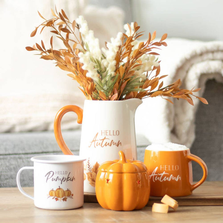 Hello Pumpkin' enamel-style mug with a playful pumpkin design, ideal for sipping fall beverages.