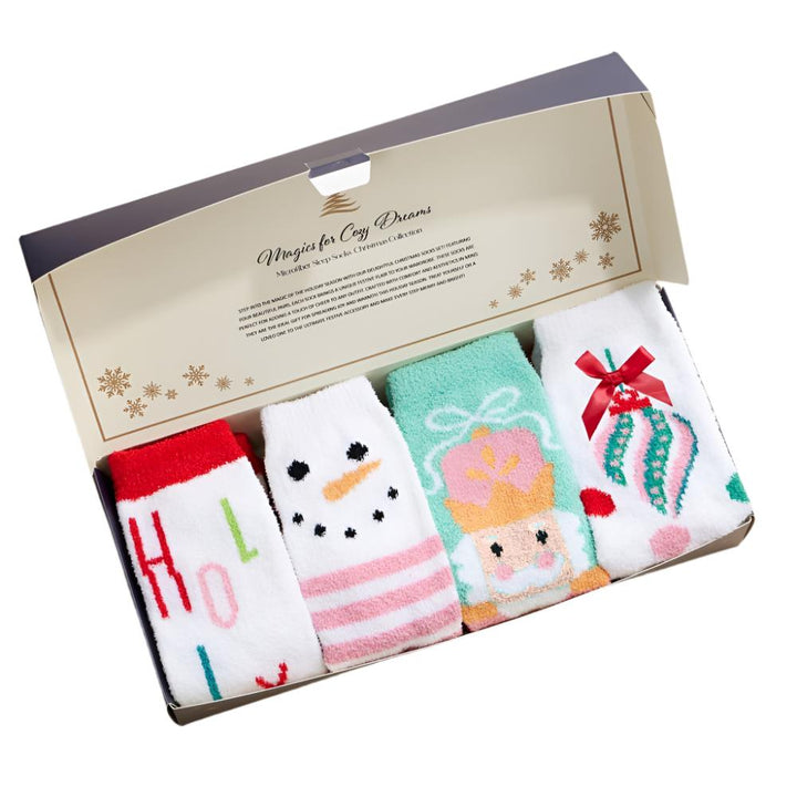 Socks in gift box: Set of four holiday socks in a gift box with Nutcracker, Snowman, Holly Jolly, and Ornament designs.