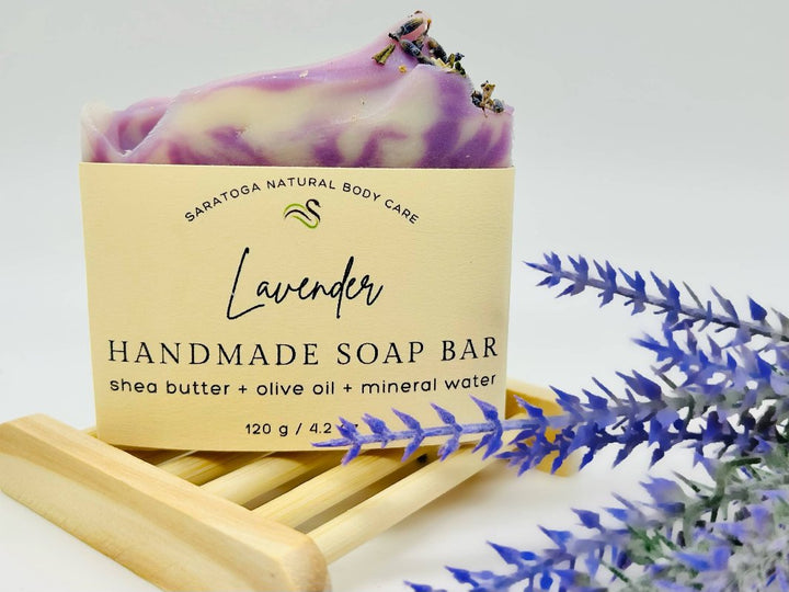 Close-up of Lavender Handmade Soap showing eco-friendly packaging and lavender sprigs. 