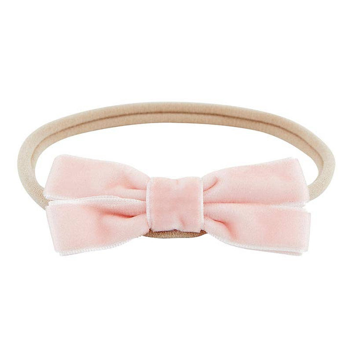 Soft baby headband with light pink velvet bow. 