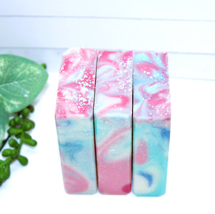 Three Mermaid Cove Soap Bars arranged together, highlighting the unique natural color patterns and glitter details.