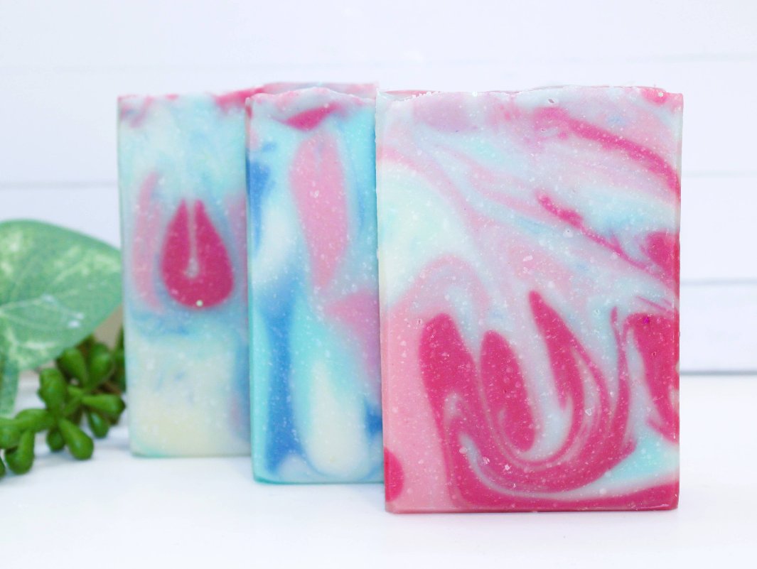 Side view of Mermaid Cove Soap Bars, focusing on the handcrafted layers of pink, blue, and glitter.