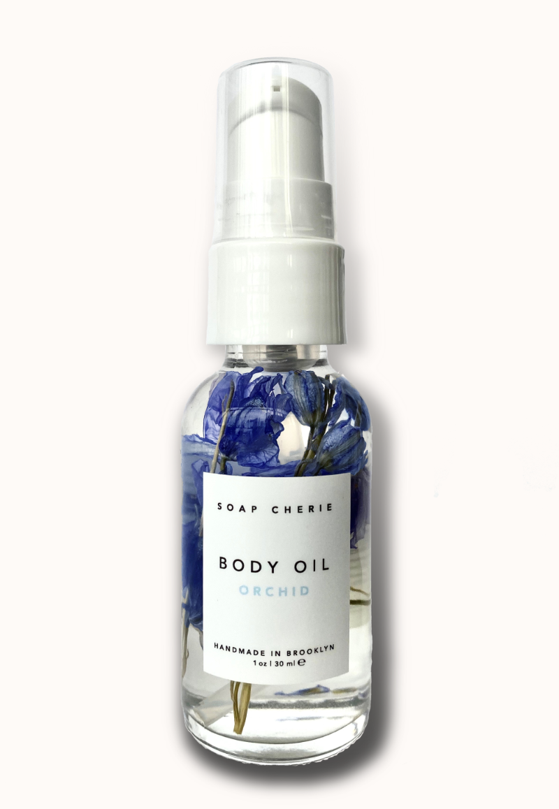 Bottle of Orchid Body Oil, a nourishing blend of cold-pressed botanical oils with soothing lavender and patchouli scent, perfect for daily hydration.