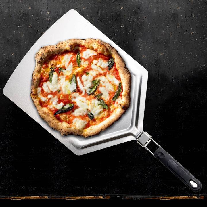 Oversized pizza peel supporting a freshly baked pizza on a grill.