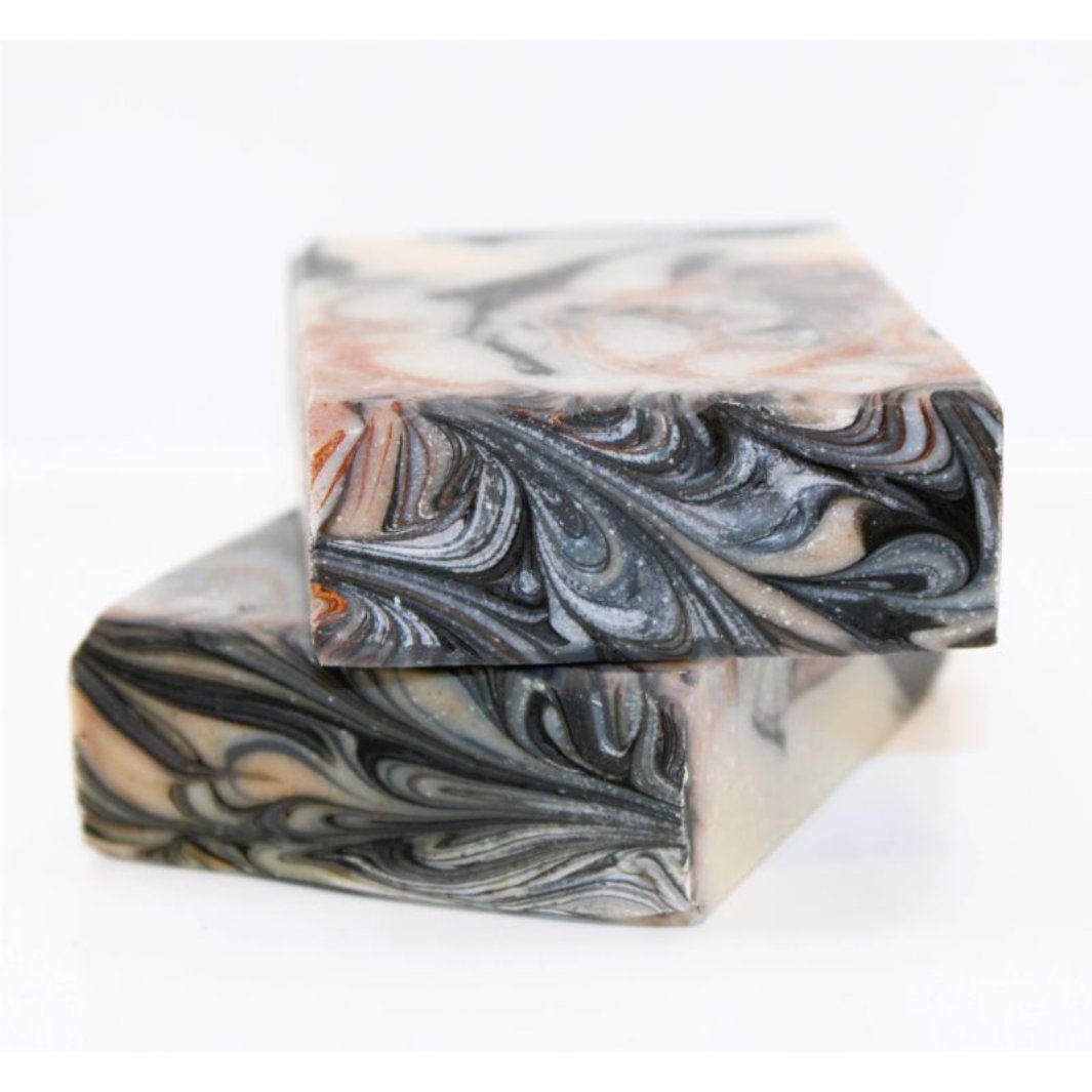 Palo Santo Soap Bar showcasing its beautiful black and grey and brown swirls with a  textured finish.