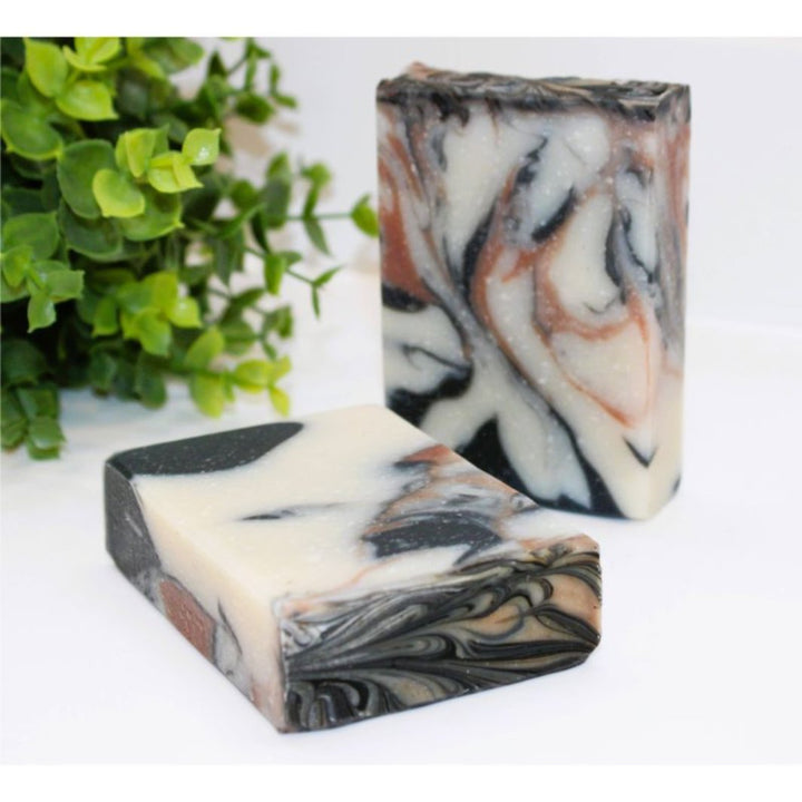 Palo Santo Soap Bar showcasing its sleek black and earthy tones with a natural, textured finish.