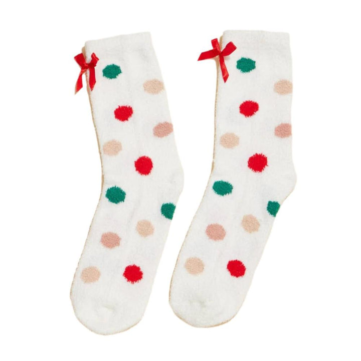 Side view of white fuzzy polka dot socks with colorful dots and a red bow detail.