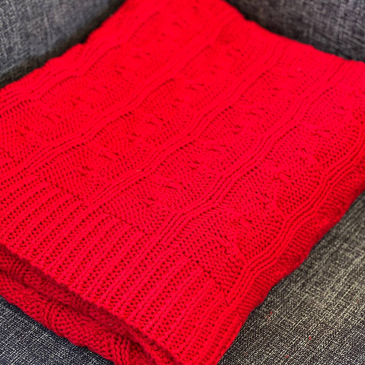 Close-up of the red cable knit texture on cotton throw blanket