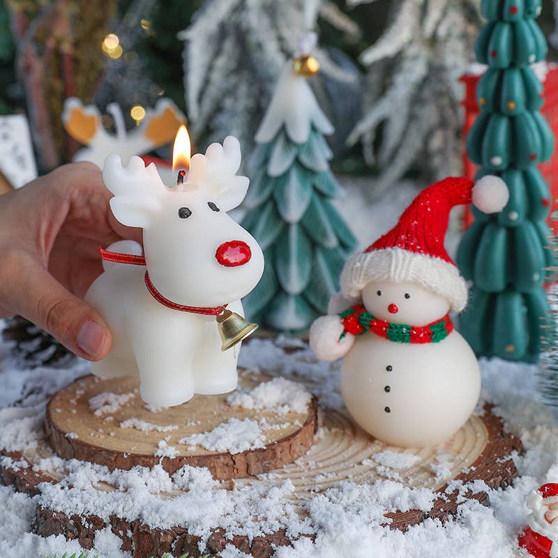 Close-up of reindeer candle with cinnamon, pine, and vanilla scent next to snowman.