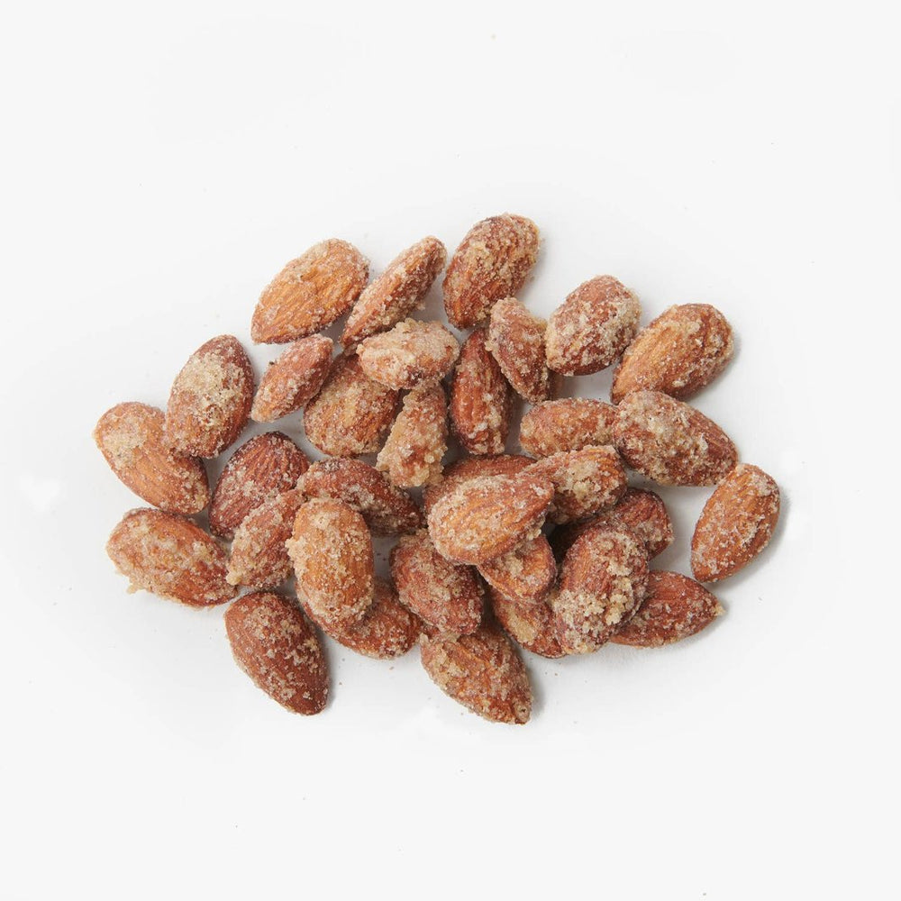 Close-up of candied almonds with a rosemary and truffle coating, showcasing their gourmet appeal.