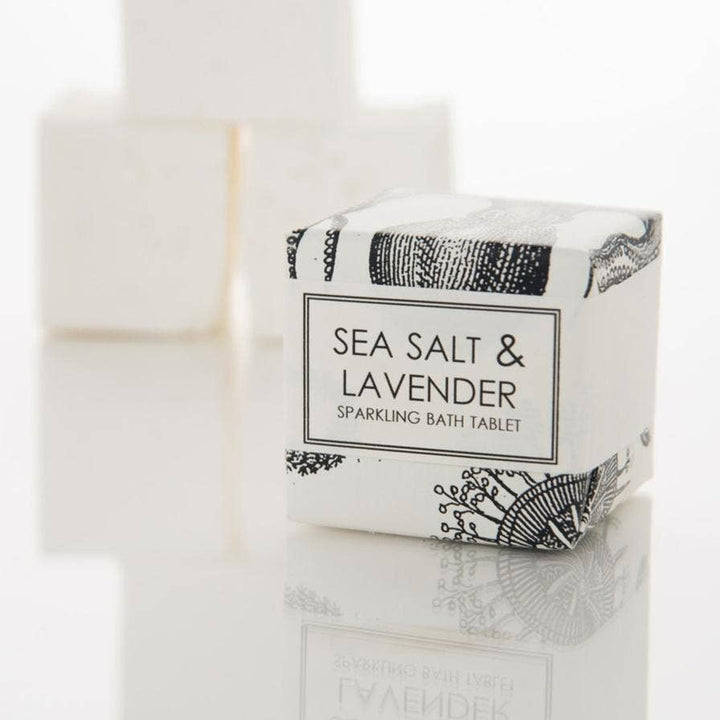 Sea Salt & Lavender Sparkling Bath Tablet by Formulary 55, an 8oz tablet that fizzes and dissolves in water for a relaxing bath. Perfect for spa gift baskets and relaxation gifts.