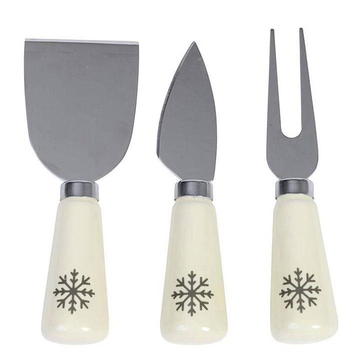 Close-up of the Snowflake Cheese Knives Set with cheese fork, bell knife, and spatula. Stainless steel with snowflakes on the ceramic handles. 