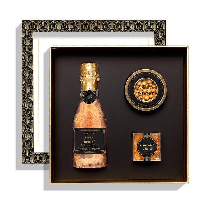 Close-up of the open Sugarfina Champagne & Caviar Gift Box, showcasing the Bubbly Bears Celebration Bottle, Gold Chocolate Caviar Tin, and Champagne Bears®.