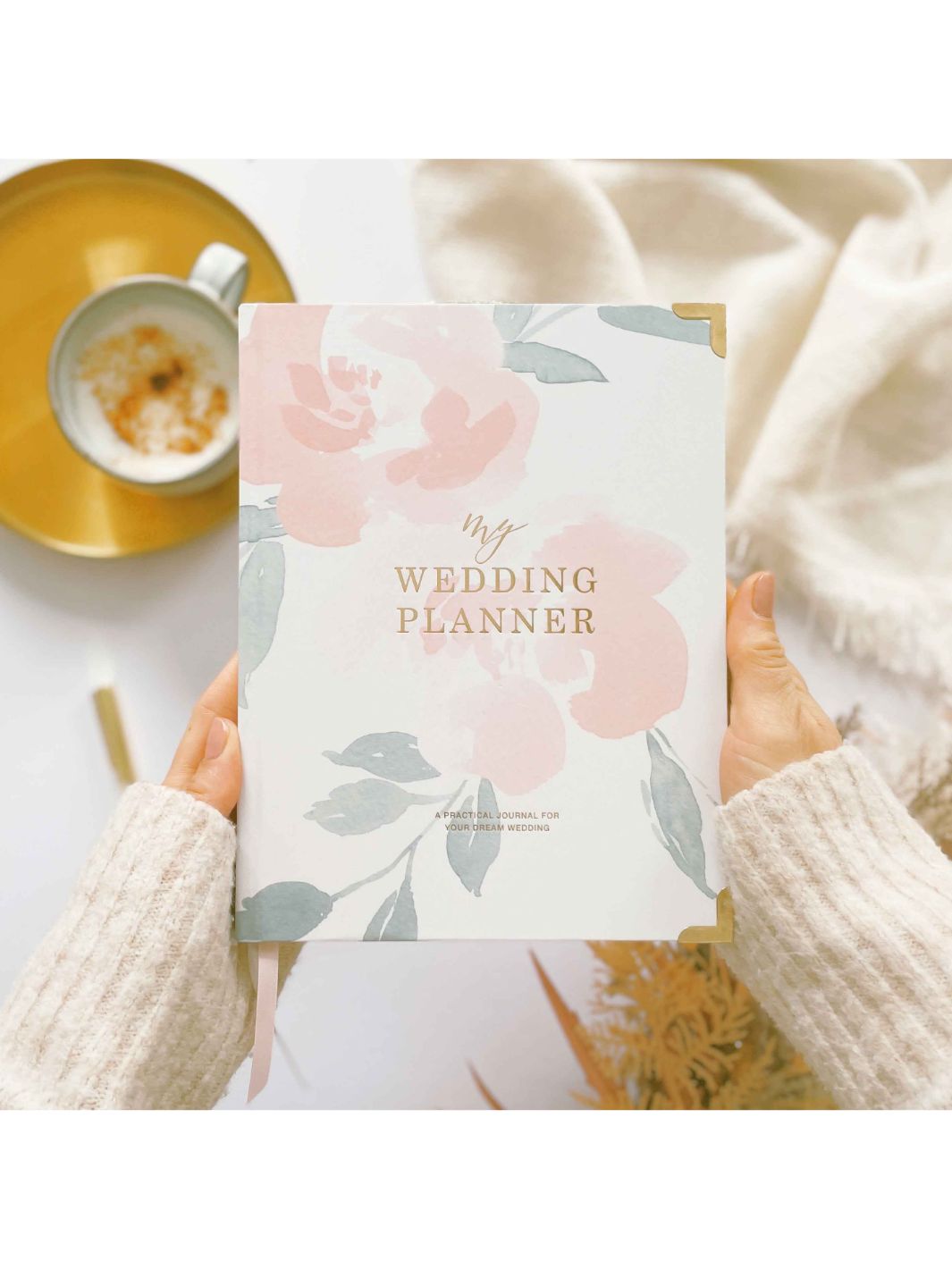 Cover Image of Wedding Planner. White with beautiful floral pattern in pink and green with gold foil lettering that states "My Wedding Planner".