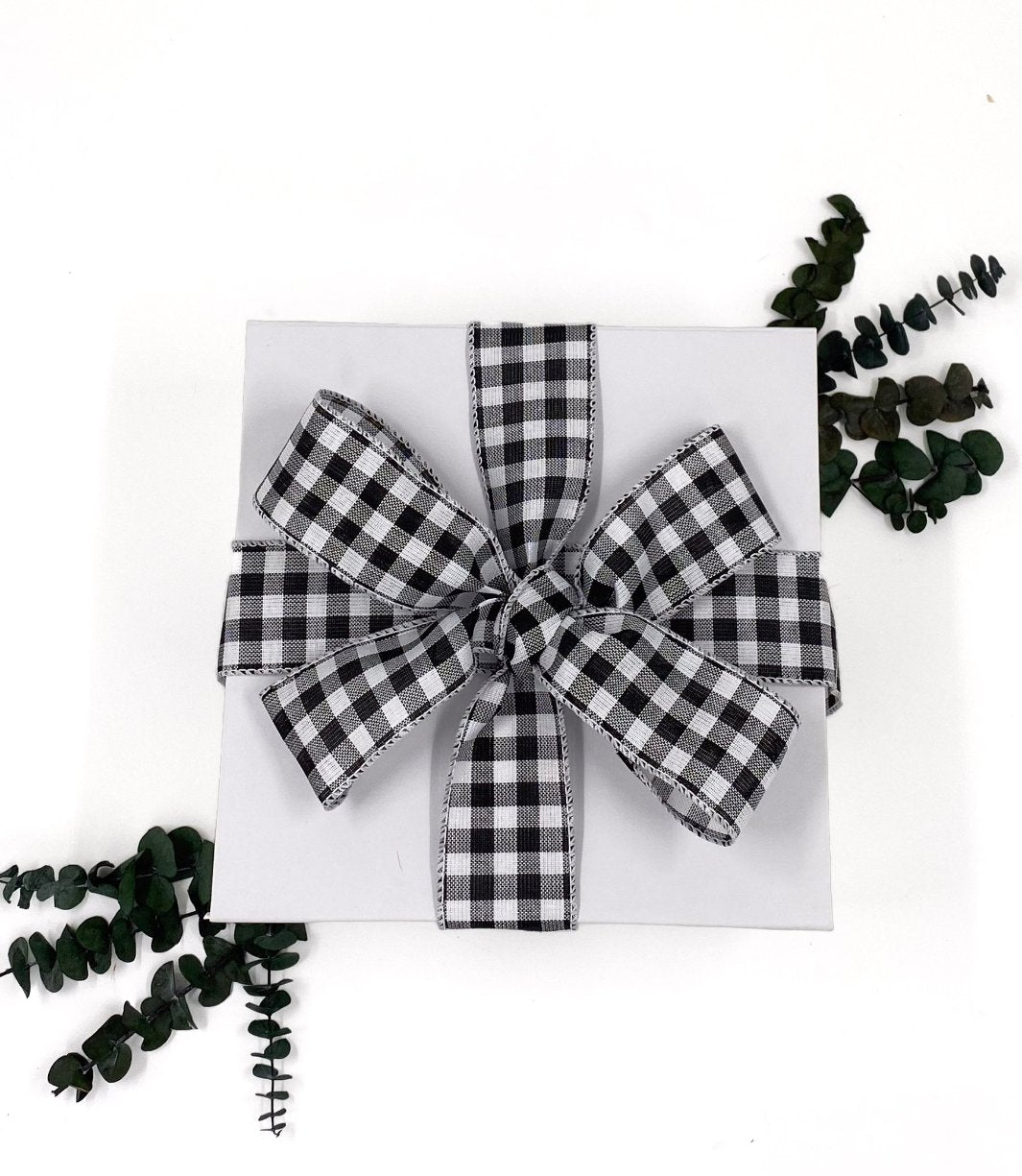 White World of Gifting Gift Box with Black and White Checkered Ribbon.