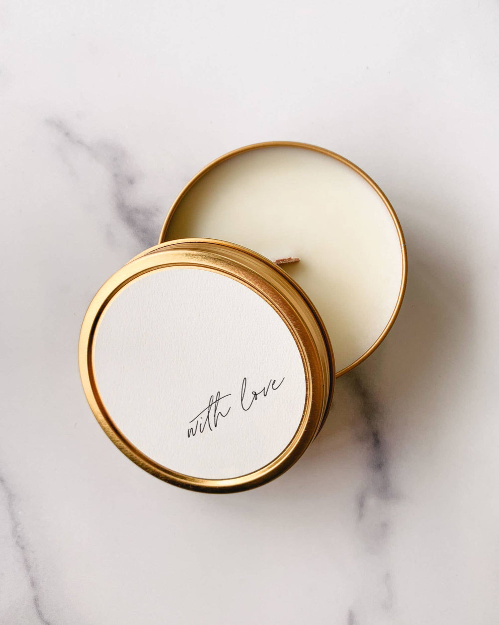 Close-up of the wooden wick and smooth soy wax inside the gold tin.