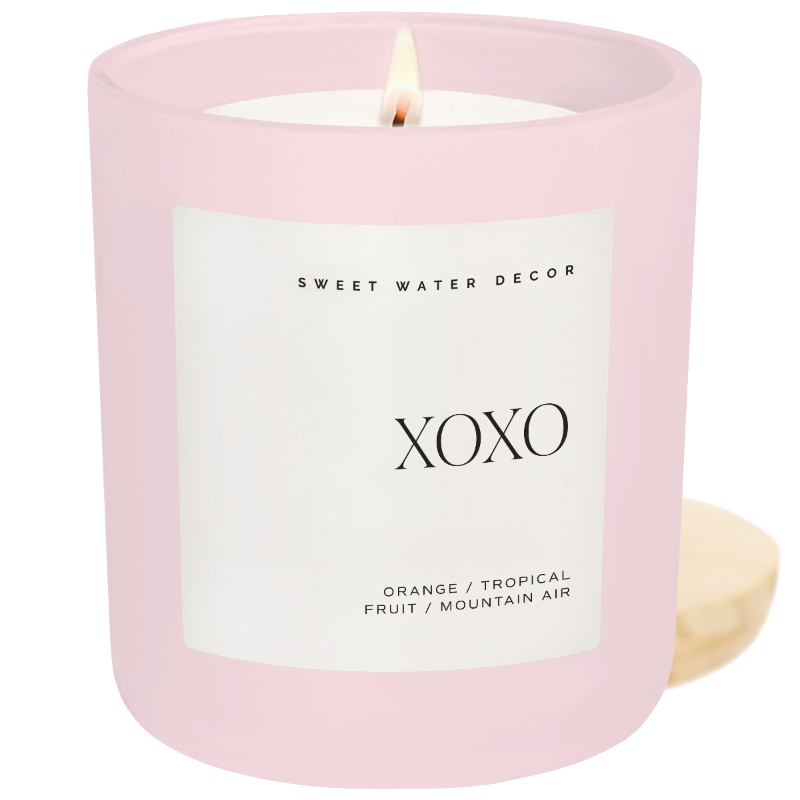 Close up of the XOXO Soy Candle in a matte pink jar.