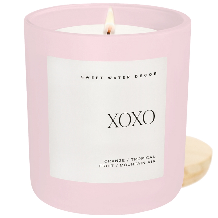 Close up of the XOXO Soy Candle in a matte pink jar.