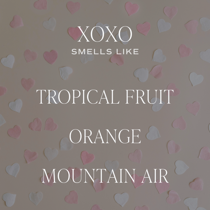 XOXO Candle smells like Tropical Fruit, Orange, and Mountain Air.