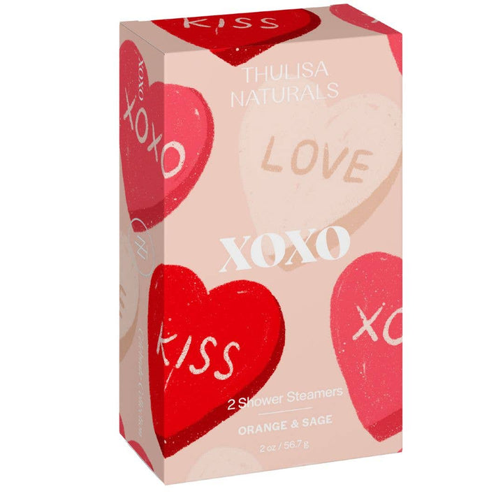 Close-up of the XOXO Shower Steamers gift box, featuring red, pink, and natural-colored hearts with "XOXO" and "Love" written on the packaging.